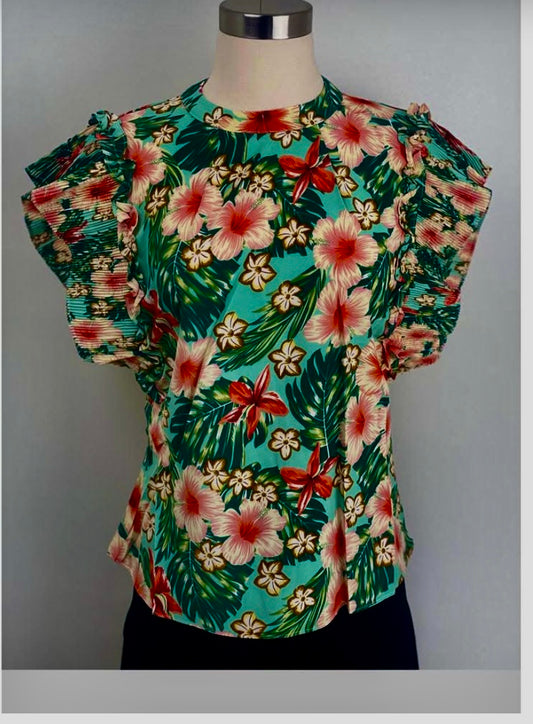 Floral patterned top on a mannequin against a gray background