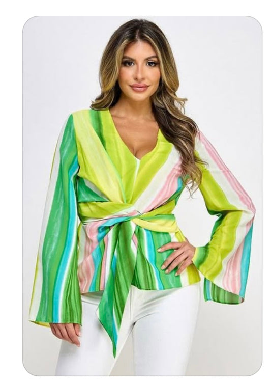 Woman wearing a colorful striped top with a white background