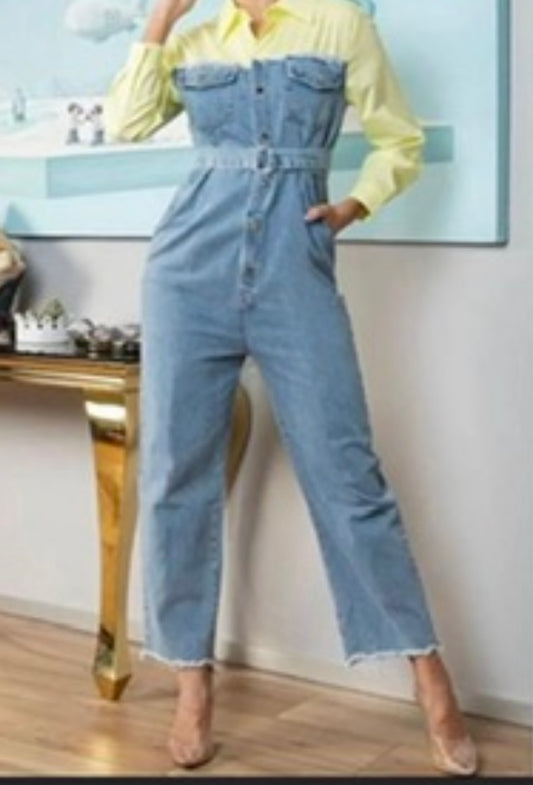 Person wearing a denim jumpsuit with a yellow top in an indoor setting.