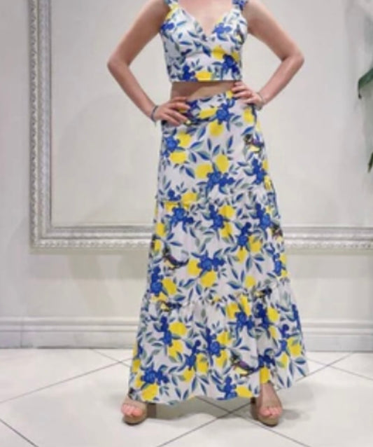 Woman wearing a floral two-piece outfit with a white background