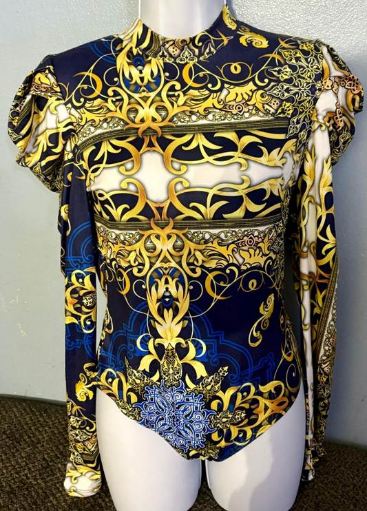 Elegant blue and gold patterned outfit on a mannequin against a plain background