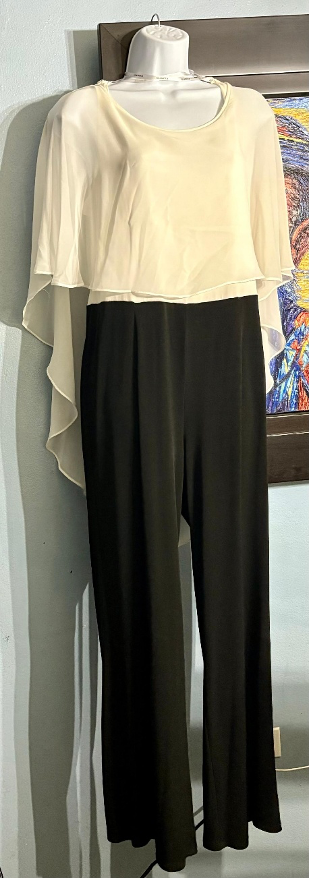Mannequin wearing a beige top and black pants against a colorful abstract painting.